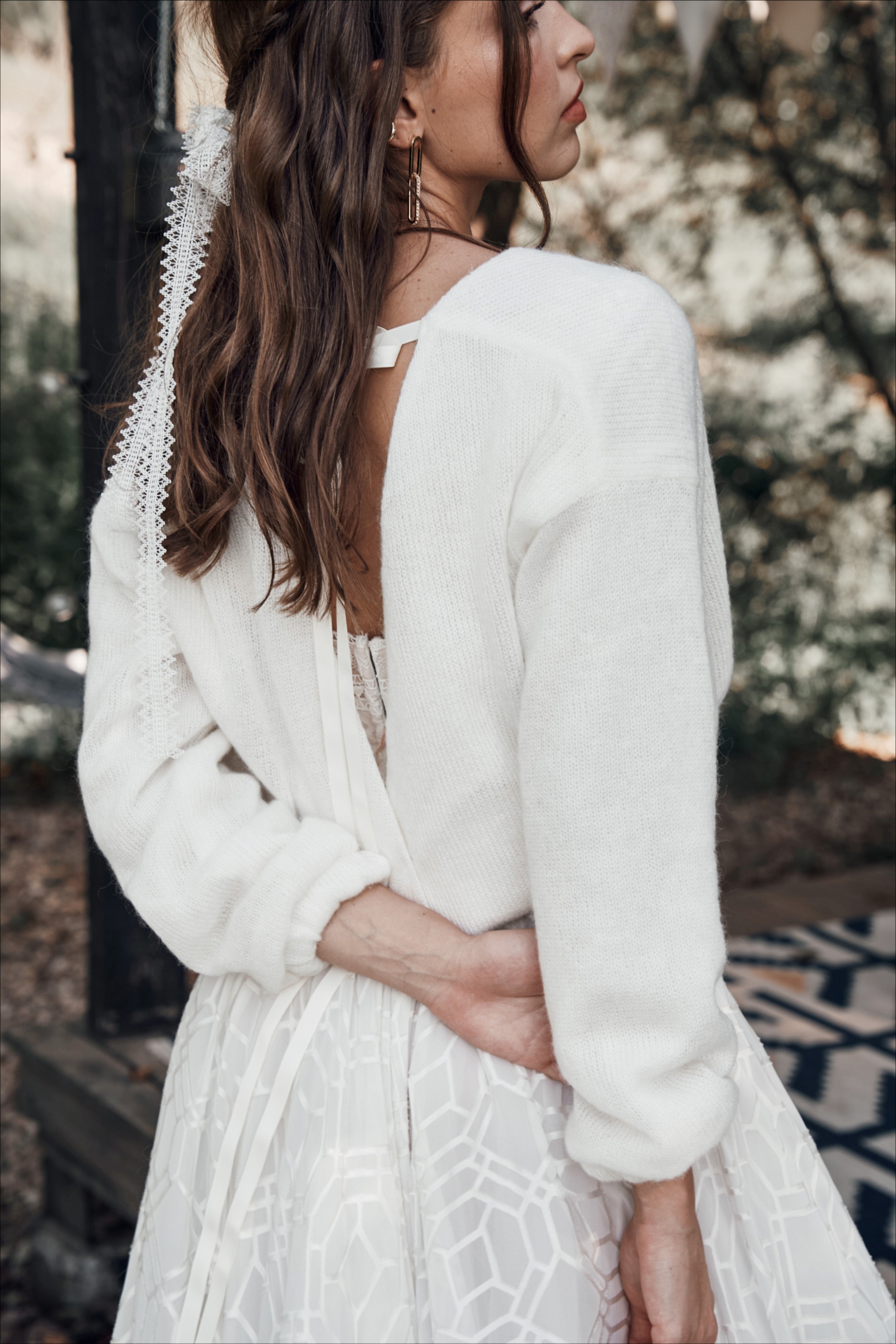 Ivory-colored wedding pullover with ribbons at the back.