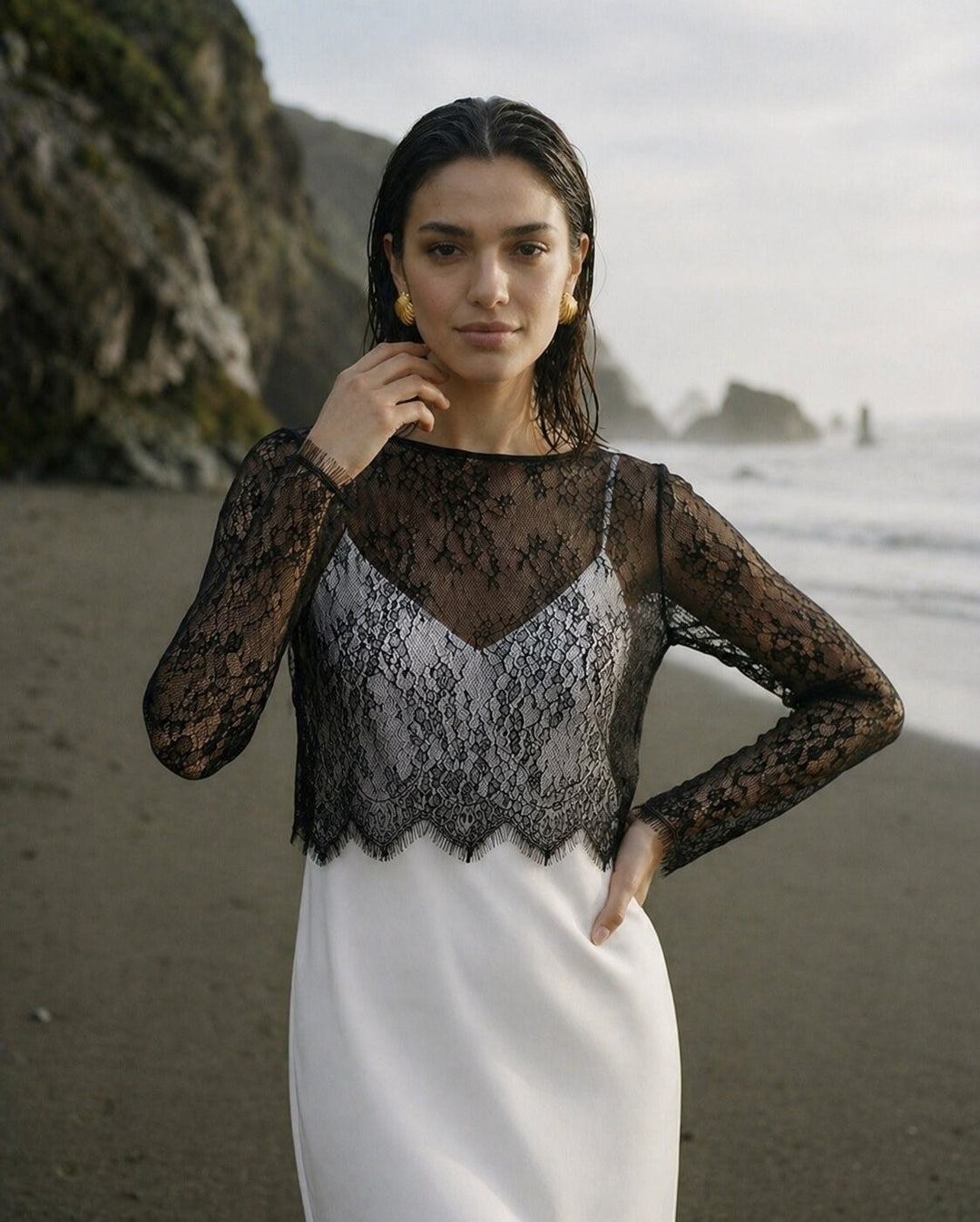 Woman wearing a black sheer lace top with a white bridal skirt