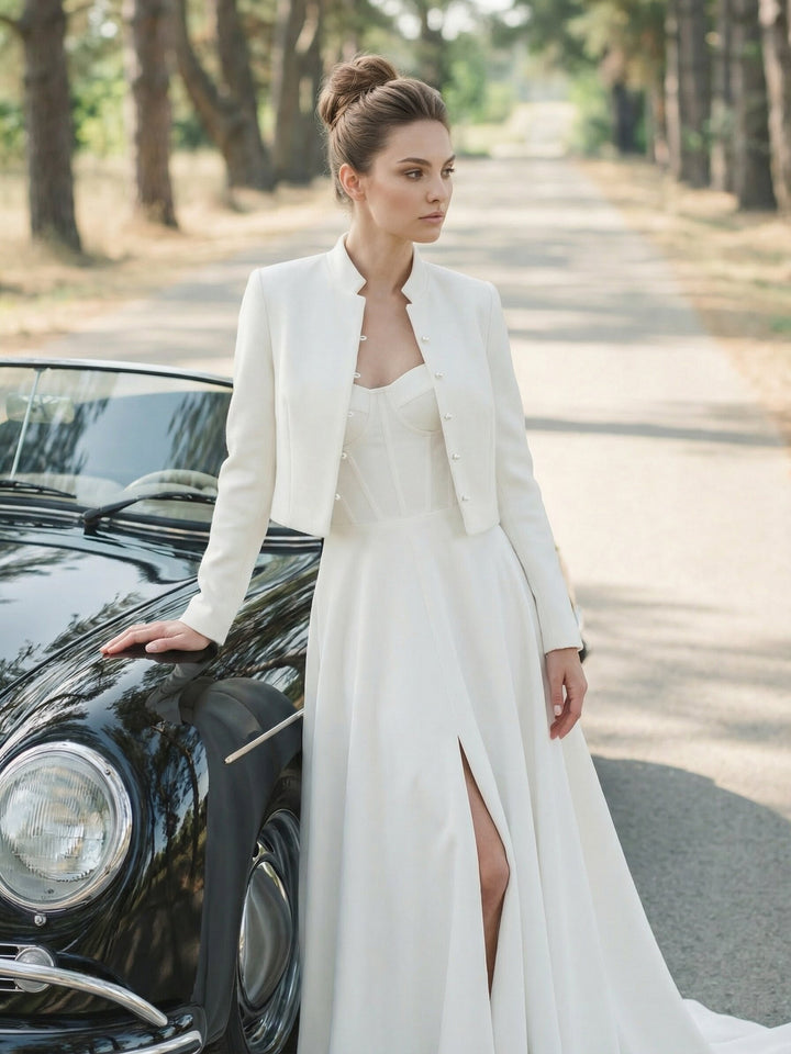 Bride wearing a cropped wool and cashmere jacket with a long white bridal skirt