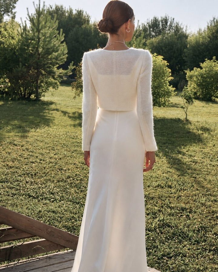 Back view of an ivory wedding cardigan worn with a fitted bridal dress