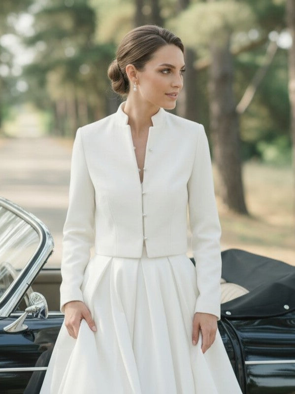 Bride wearing a tailored ivory bridal blazer over a white wedding dress