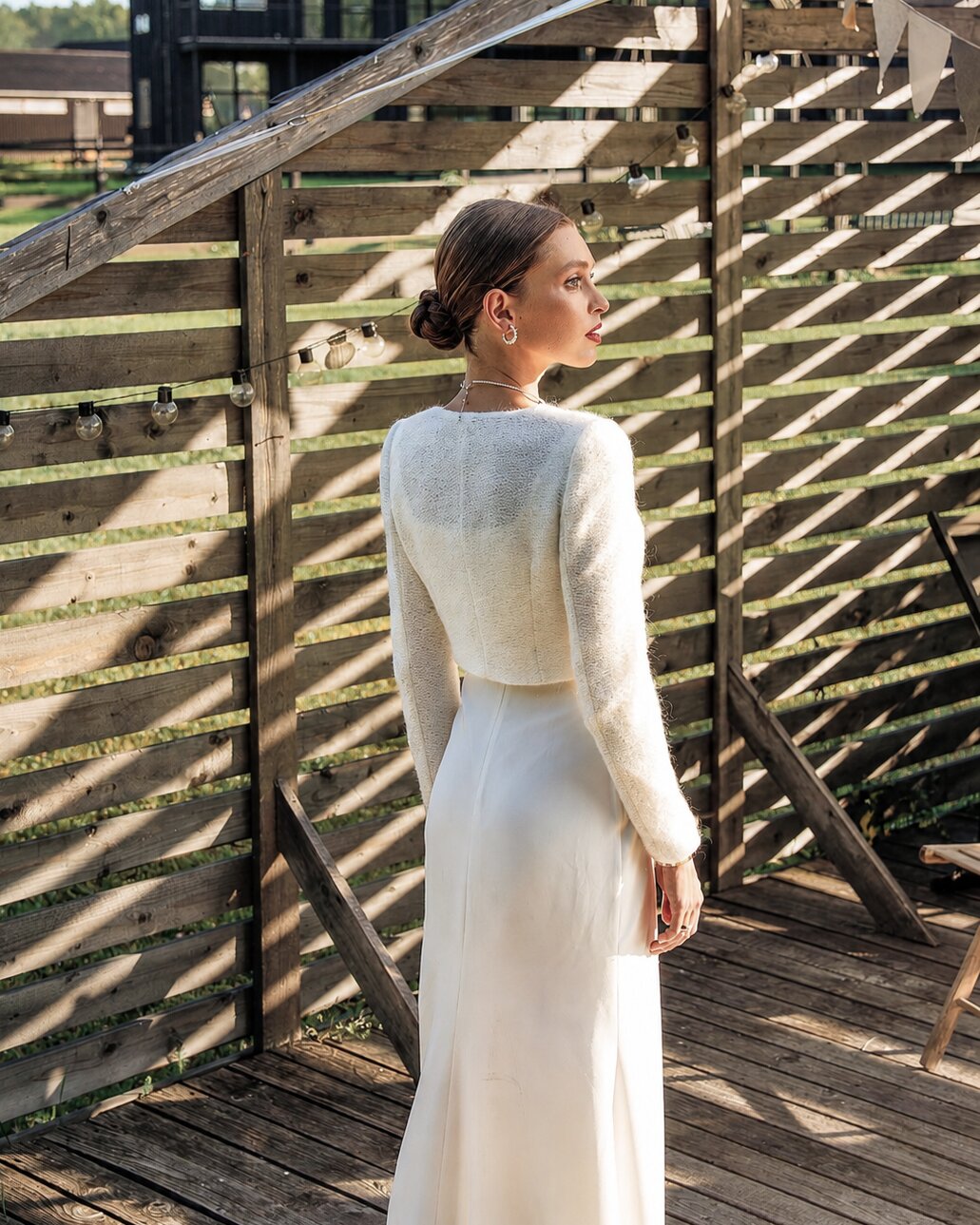 Bride in an ivory bolero-style layer over a long white wedding gown