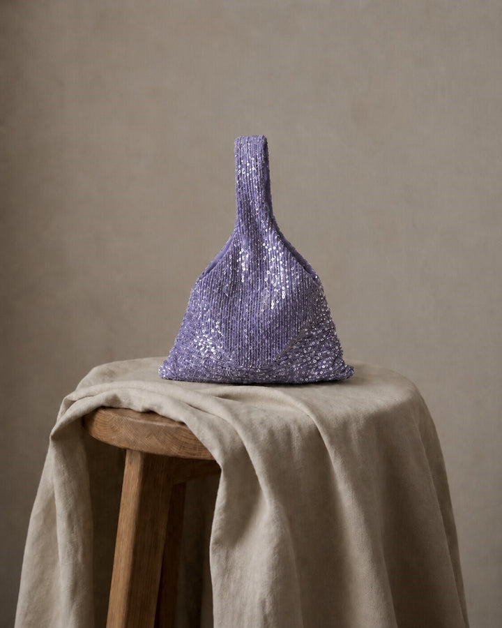 Lavender sequin wedding clutch displayed against a neutral backdrop