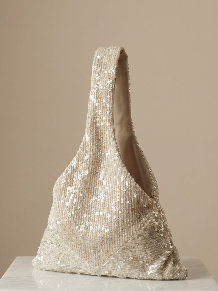 Champagne sequin Japanese Knot Purse shown upright on a neutral background