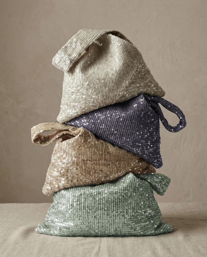 Stack of colorful sequin clutches showing multiple available shades