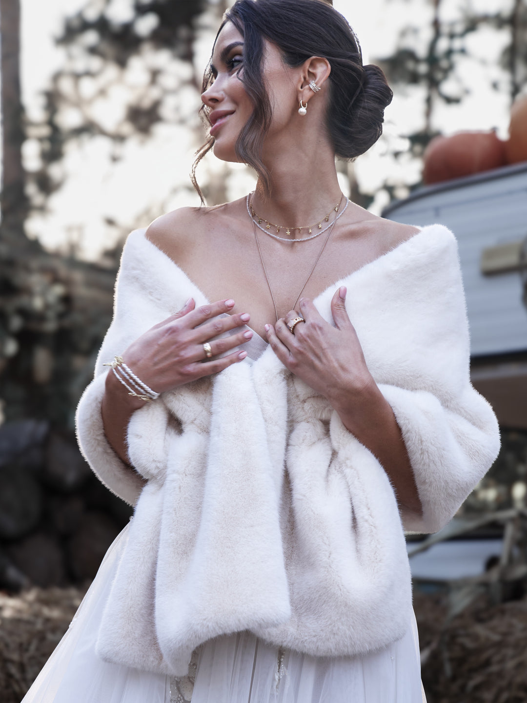 Close view of a bride wearing a soft white faux fur wedding wrap