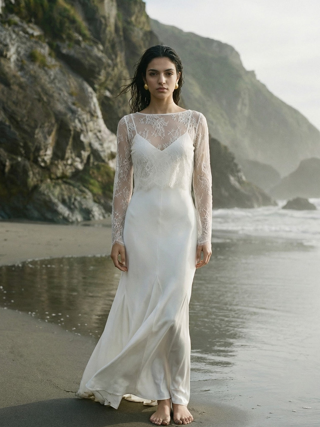 Bride wearing a sheer lace cover-up over a long white wedding dress outdoors