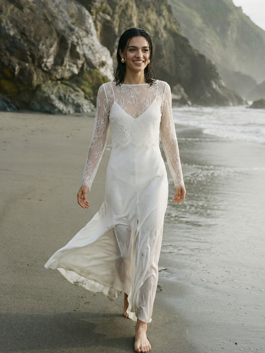 Bride wearing a lightweight lace wedding dress topper by the sea