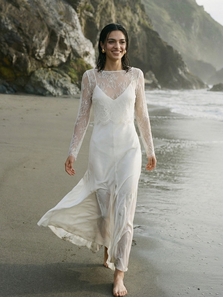 Bride wearing a lightweight lace wedding dress topper by the sea