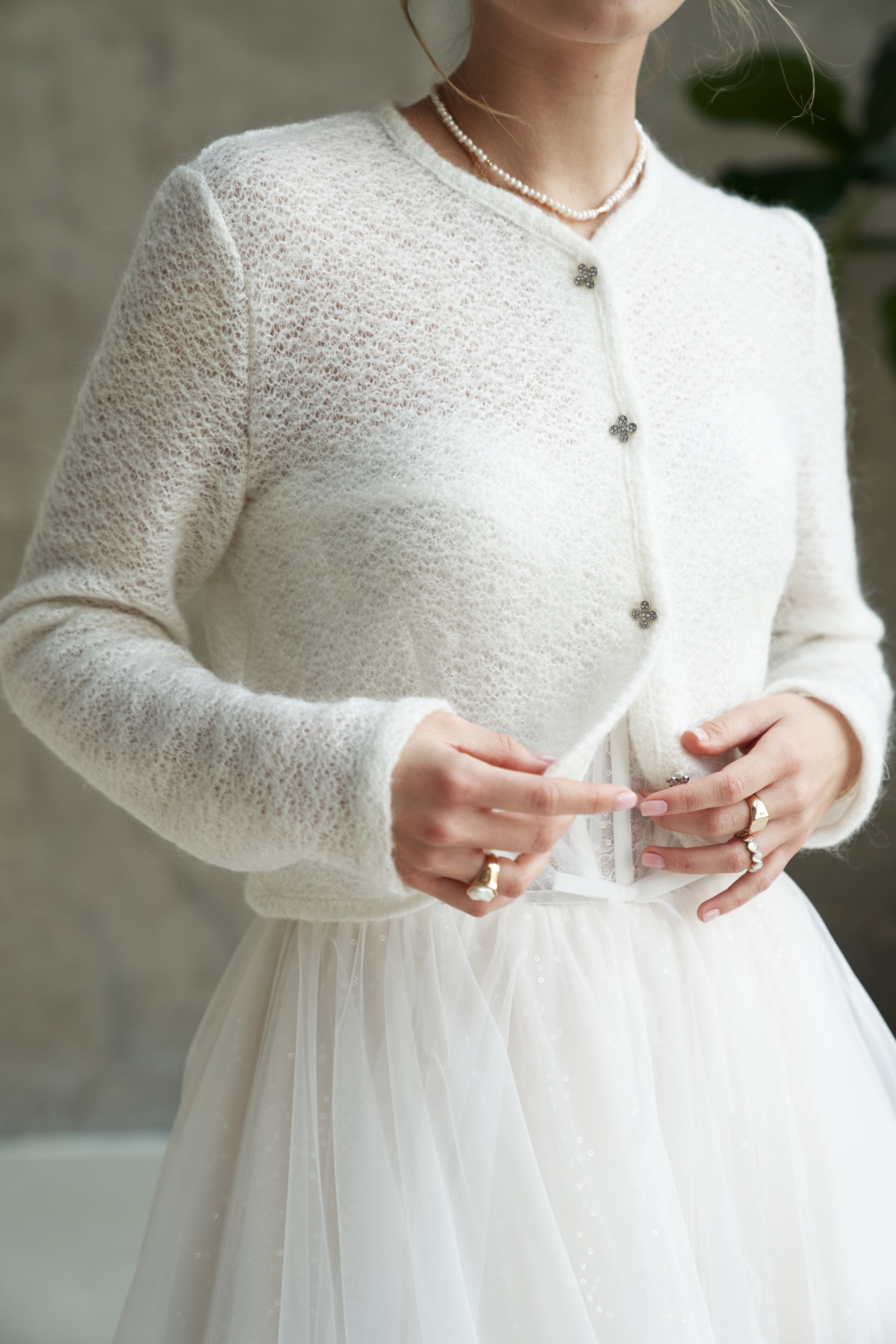 Light wedding cardigan made of wool. Knitted bridal sweater with buttons