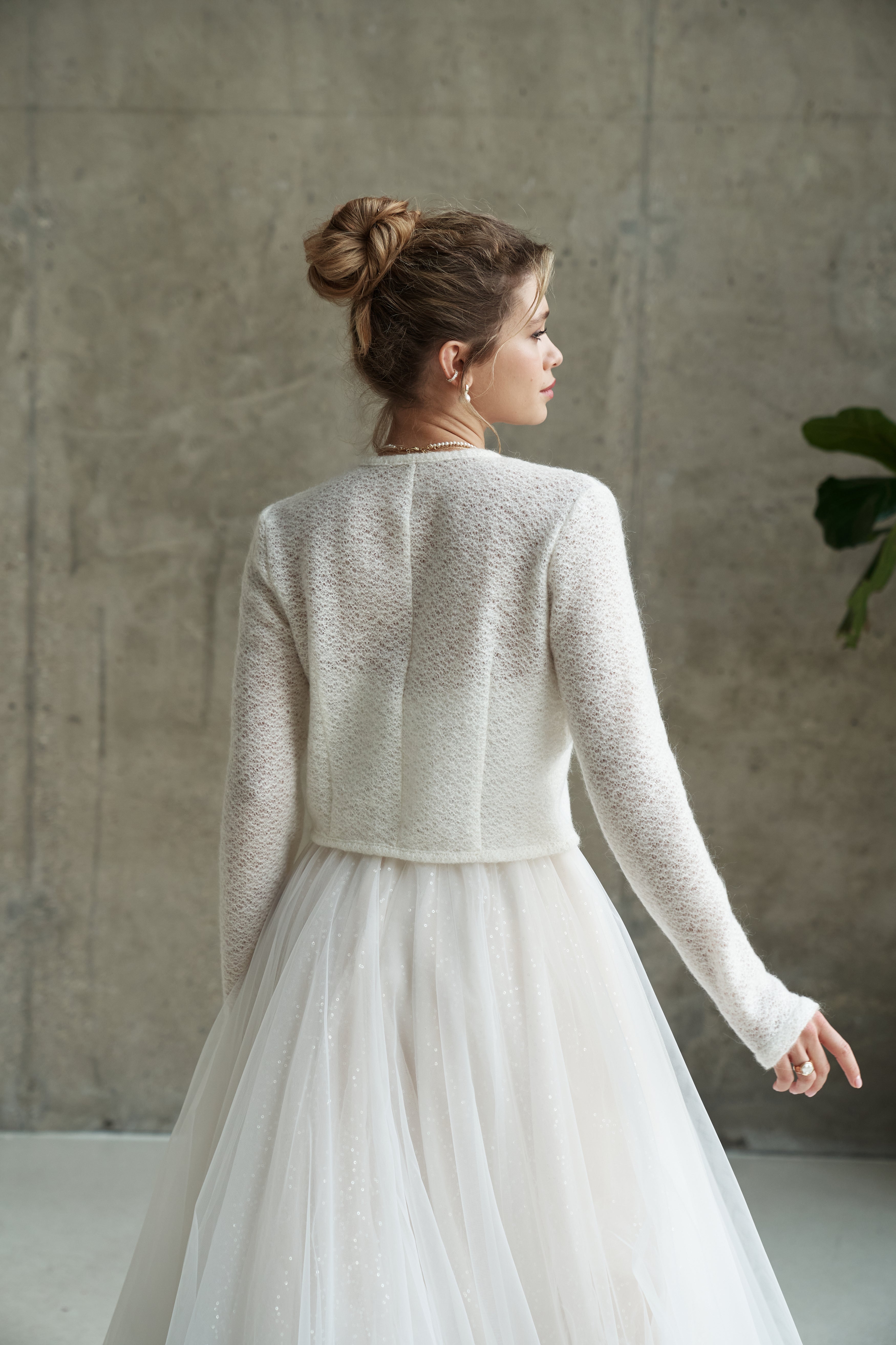 Light wedding cardigan made of wool. Knitted bridal sweater with buttons
