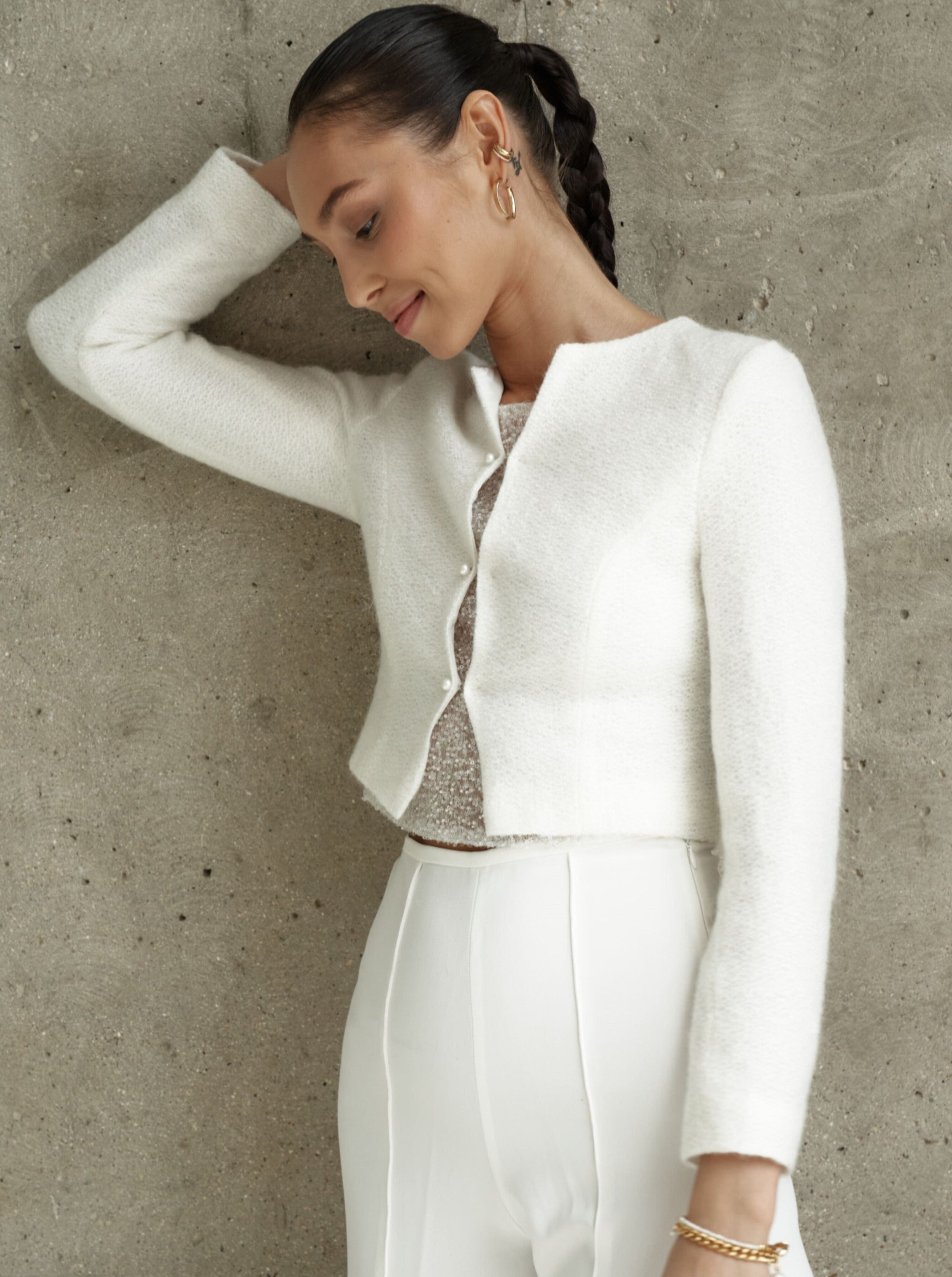 Bridal knitted jacket made of wool. Cropped-style wedding coat
