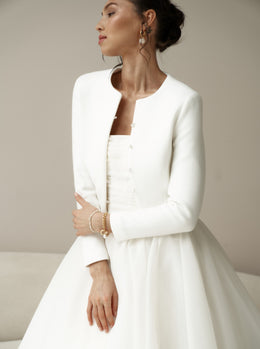 Bridal jacket in classic style with pearl buttons. Wedding coat for br ...