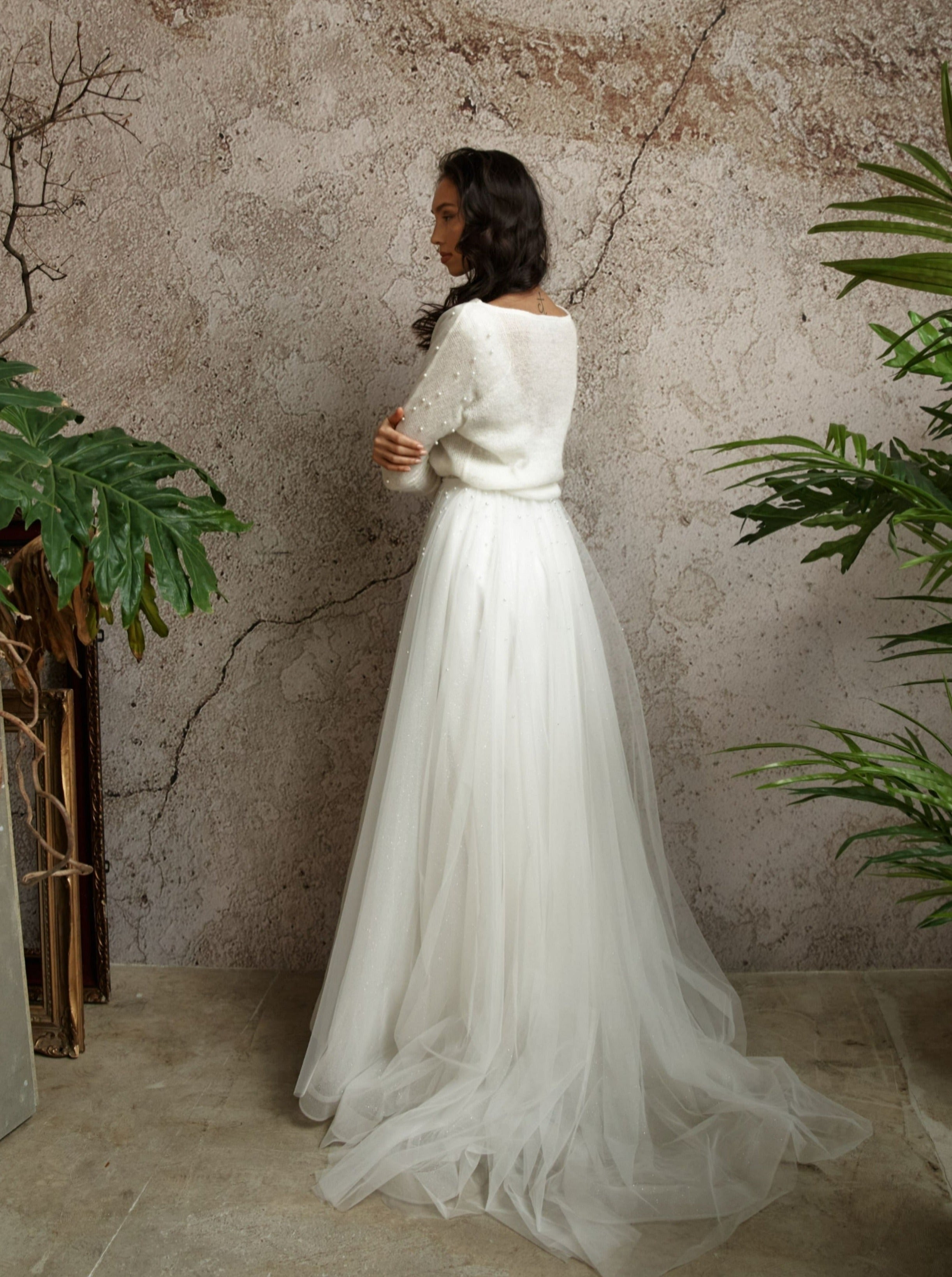 Knitted bridal pullover with decorated sleeves.